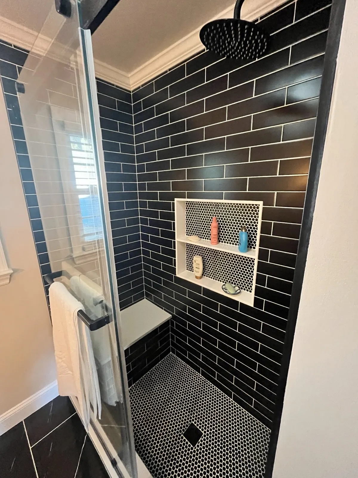 A tiled shower with a recessed niche, from a Kubat Construction bathroom remodel