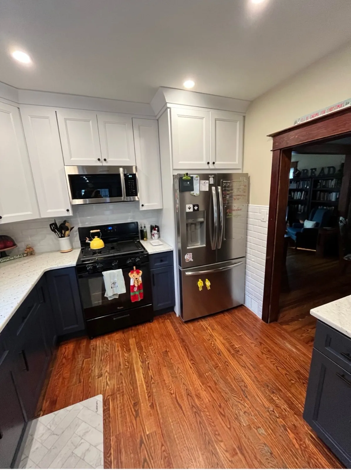 Kitchen with dark lower cabinets and white uppers, by Kubat Construction